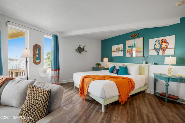 bedroom with a textured ceiling and hardwood / wood-style floors