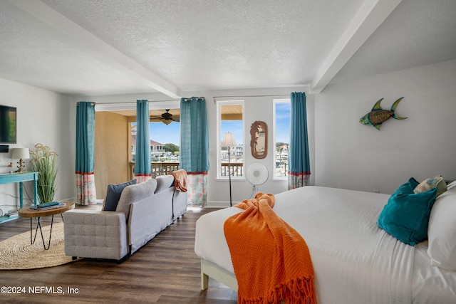 bedroom featuring a textured ceiling, beamed ceiling, and wood-type flooring