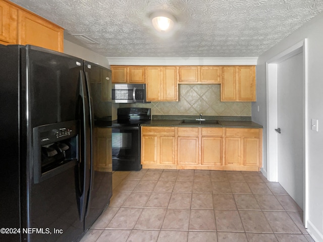 kitchen featuring tasteful backsplash, black appliances, sink, and light tile patterned flooring