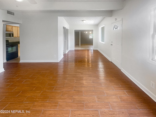 tiled empty room featuring ceiling fan