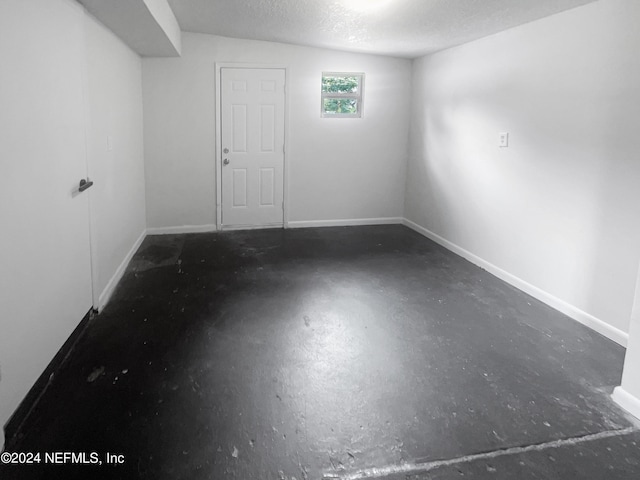 basement featuring a textured ceiling