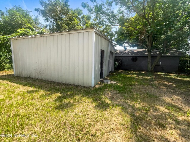 view of outbuilding featuring a yard