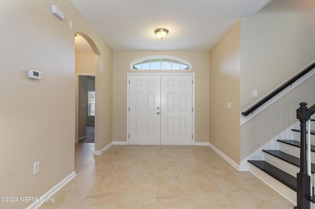 entryway with light tile patterned flooring