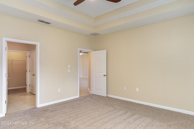 unfurnished bedroom with light colored carpet and ceiling fan