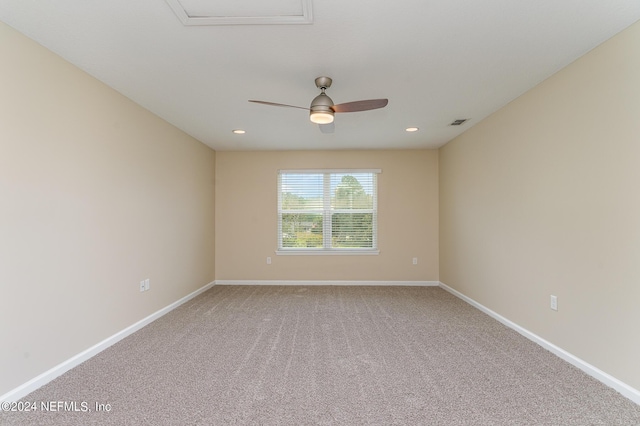 unfurnished room featuring ceiling fan and carpet