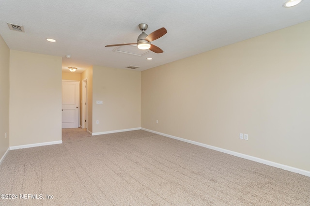 empty room featuring ceiling fan, a textured ceiling, and carpet flooring