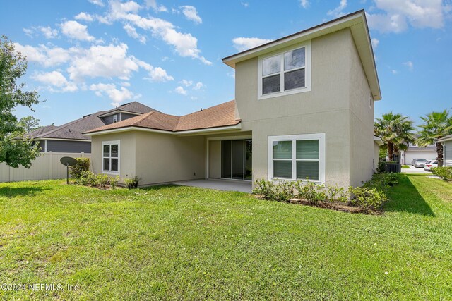 rear view of property with a yard