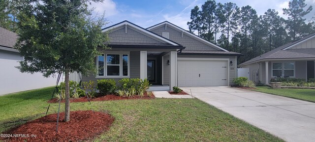 view of front of home with a garage and a front yard