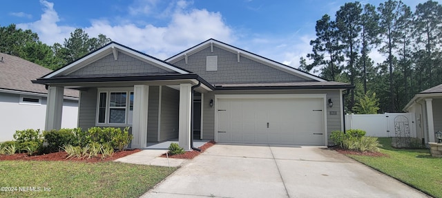 view of front facade featuring a garage and a front lawn