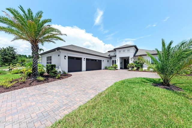 view of front of home featuring a garage and a front lawn