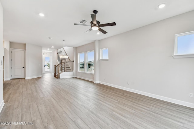 unfurnished living room with ceiling fan and light wood-type flooring