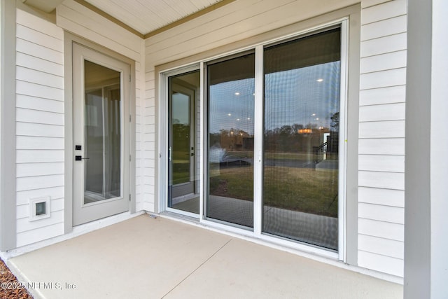 property entrance featuring a patio area