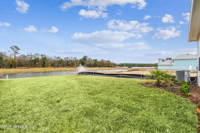 view of yard featuring cooling unit and a water view