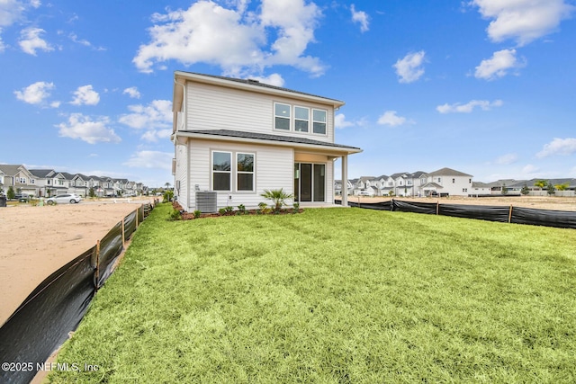 back of house with a lawn