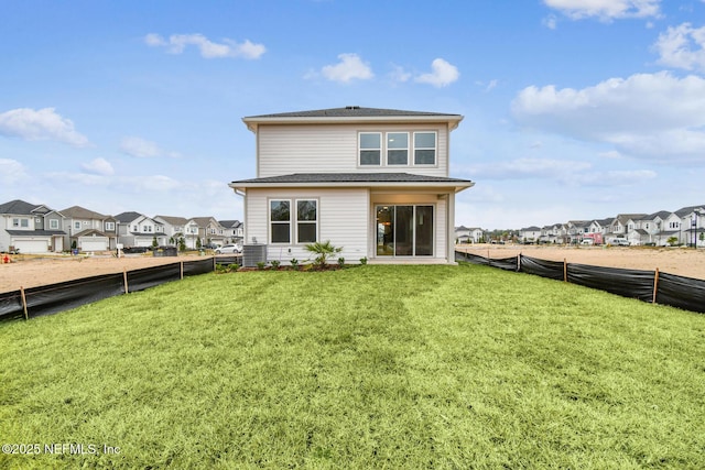 rear view of house featuring a lawn