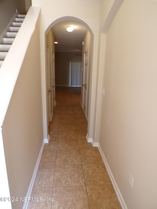 hall featuring tile patterned flooring