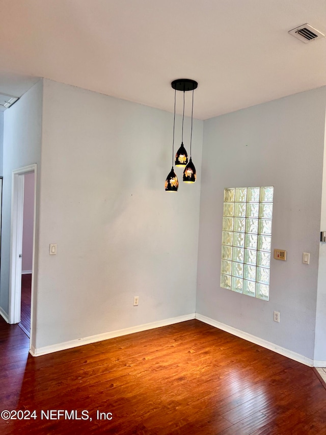 unfurnished dining area featuring dark wood-type flooring