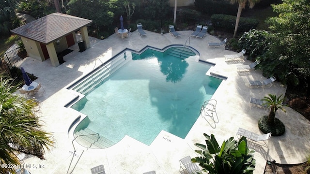 view of swimming pool with a patio