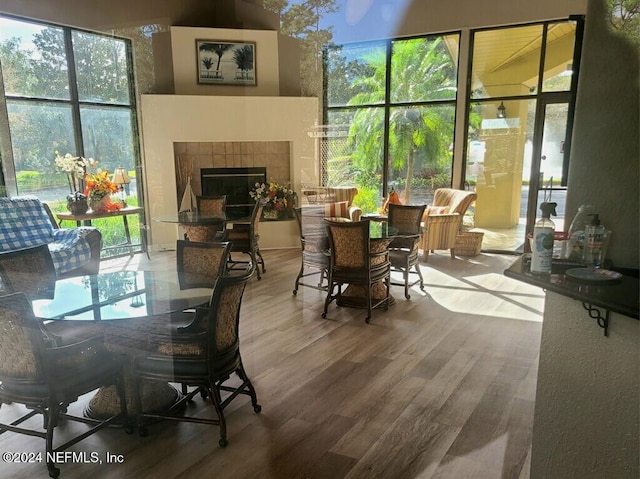 dining space featuring hardwood / wood-style flooring and a fireplace