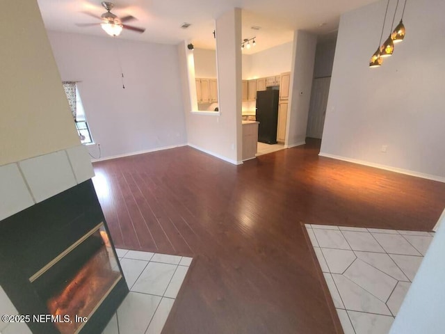 unfurnished living room with ceiling fan and light hardwood / wood-style floors