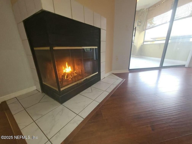 interior details featuring a tile fireplace