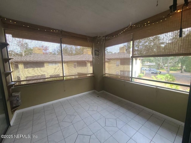 unfurnished sunroom featuring a wealth of natural light