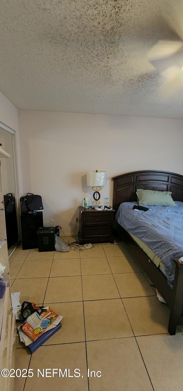 unfurnished bedroom featuring light tile patterned floors and a textured ceiling