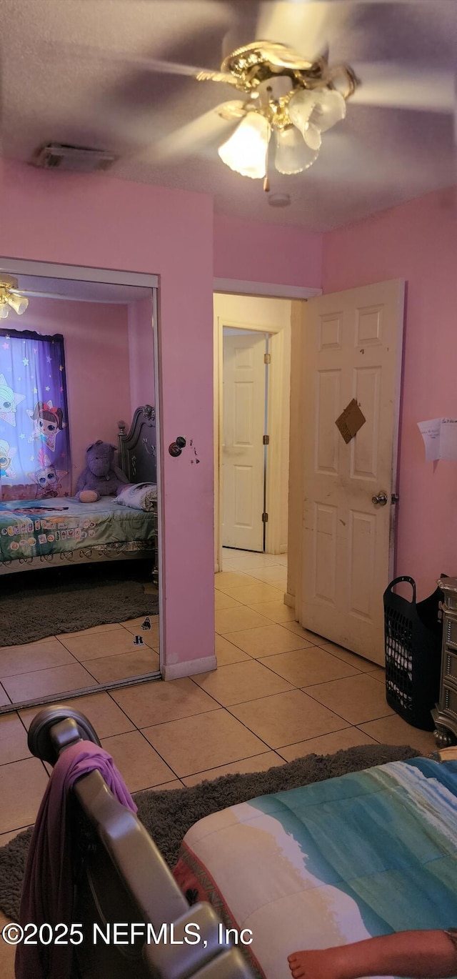 tiled bedroom with ceiling fan