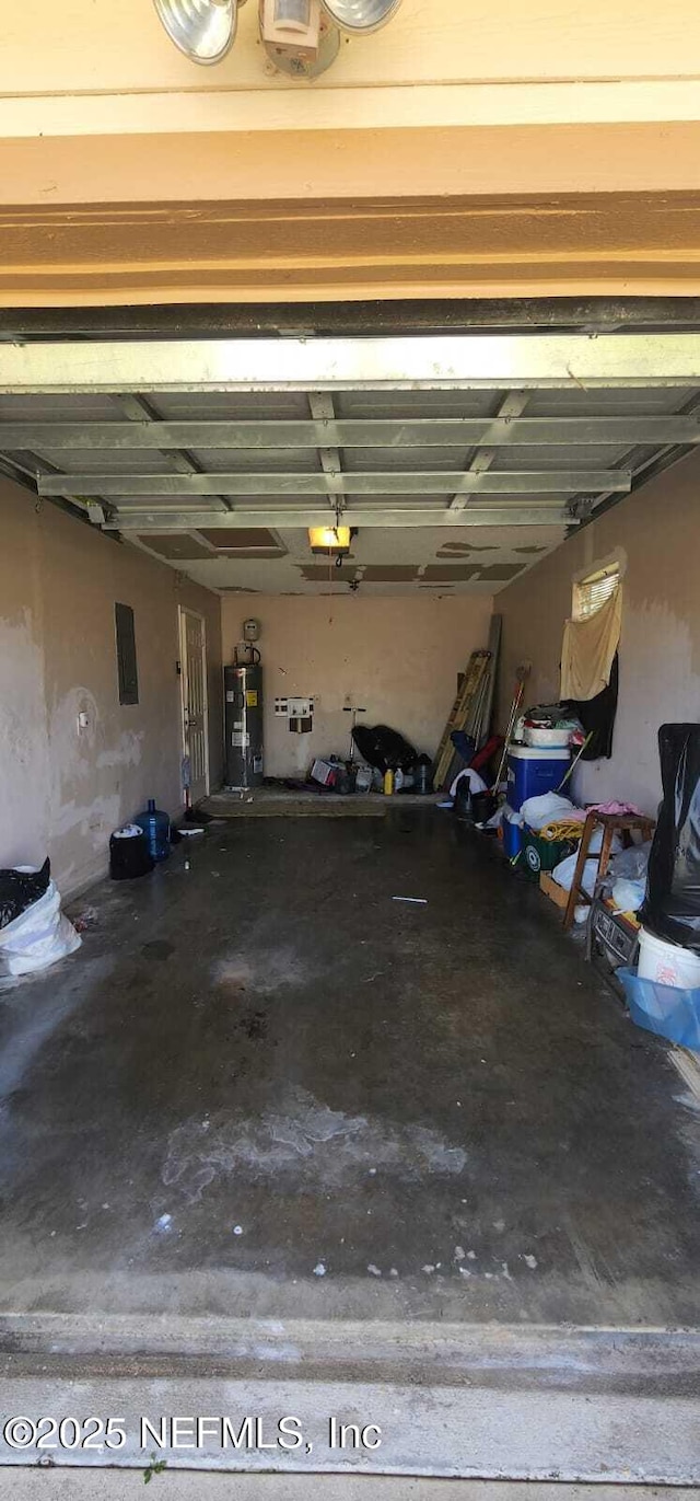 garage featuring water heater, a garage door opener, and electric panel