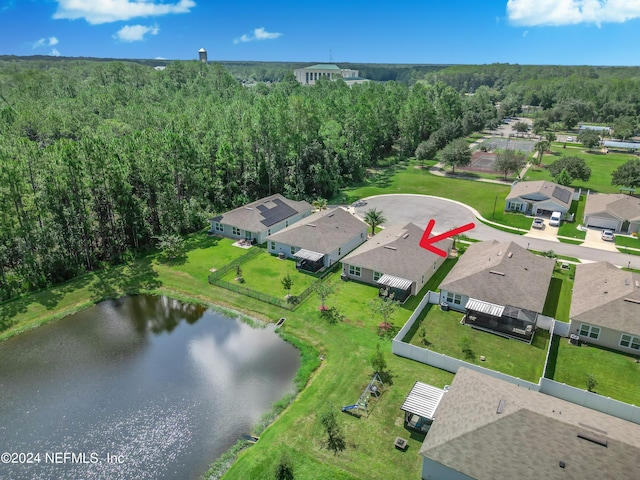 bird's eye view featuring a residential view, a water view, and a view of trees