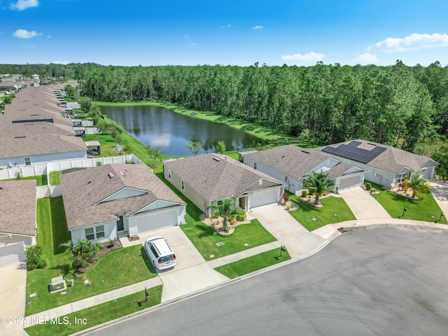 aerial view with a forest view, a water view, and a residential view