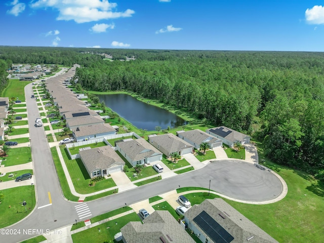 drone / aerial view featuring a water view and a wooded view