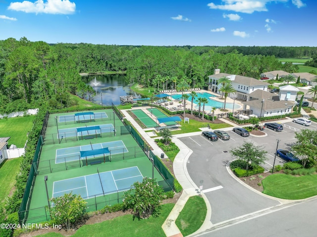 bird's eye view with a water view and a wooded view