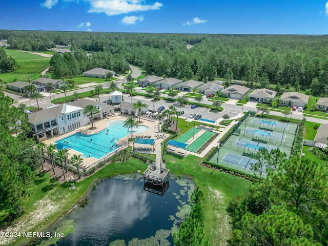 aerial view featuring a forest view and a water view