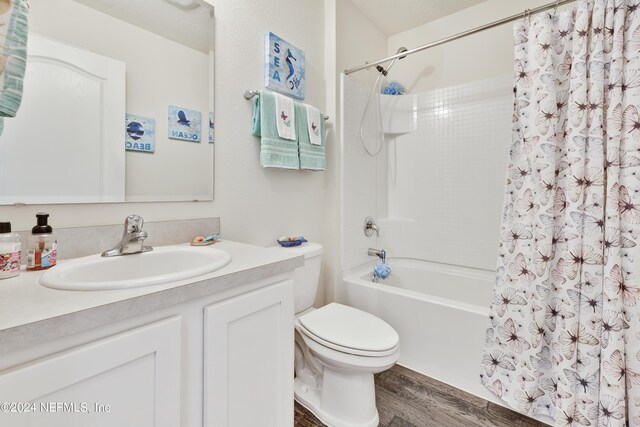 full bathroom with toilet, vanity, shower / tub combo with curtain, and wood-type flooring