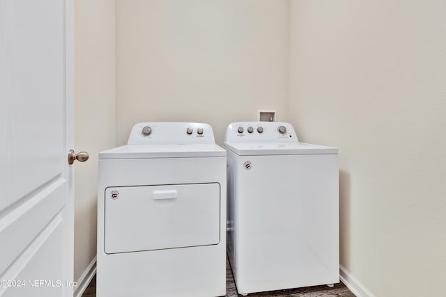 laundry area featuring laundry area, baseboards, and washing machine and clothes dryer