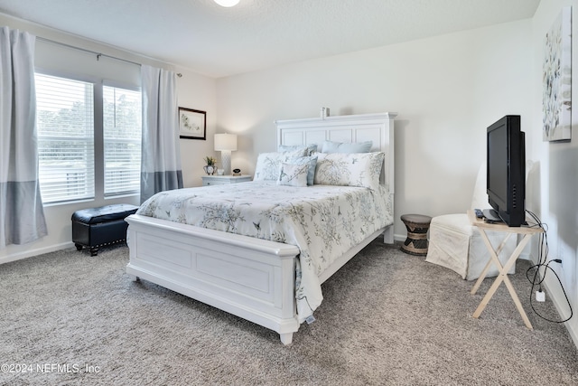 carpeted bedroom with baseboards