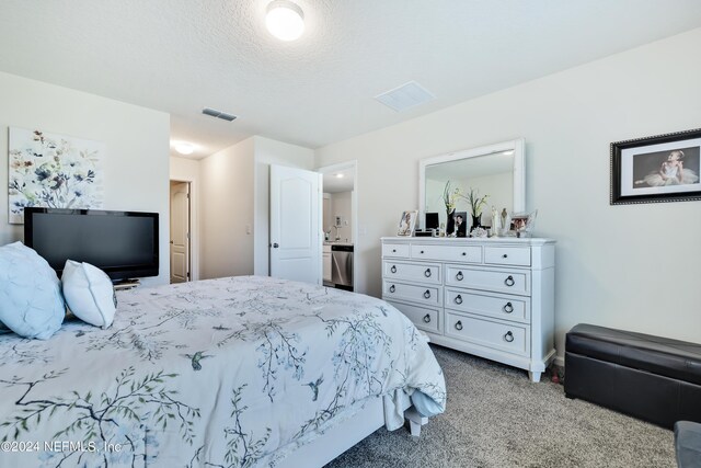 carpeted bedroom with a textured ceiling