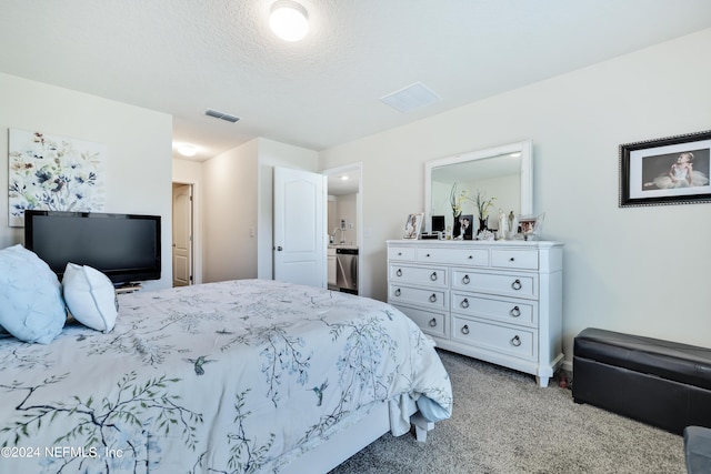 bedroom with visible vents, a textured ceiling, and light colored carpet