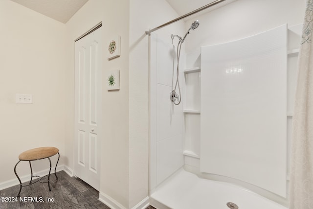 bathroom featuring hardwood / wood-style flooring and a shower