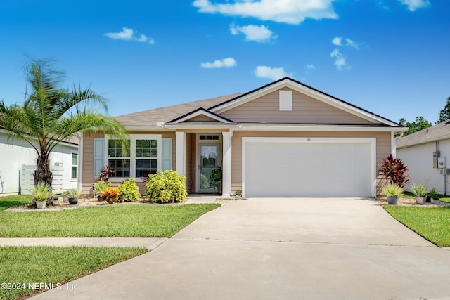 ranch-style house featuring an attached garage, concrete driveway, and a front yard