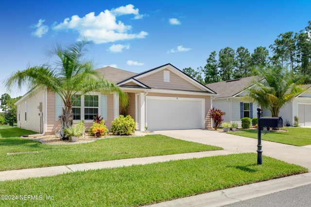 ranch-style house with a garage and a front yard