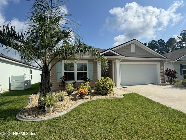 ranch-style house featuring a front yard, concrete driveway, and an attached garage