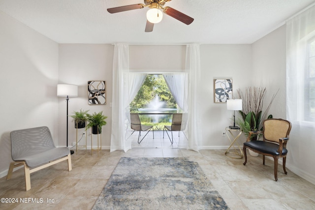 sitting room with baseboards and a textured ceiling