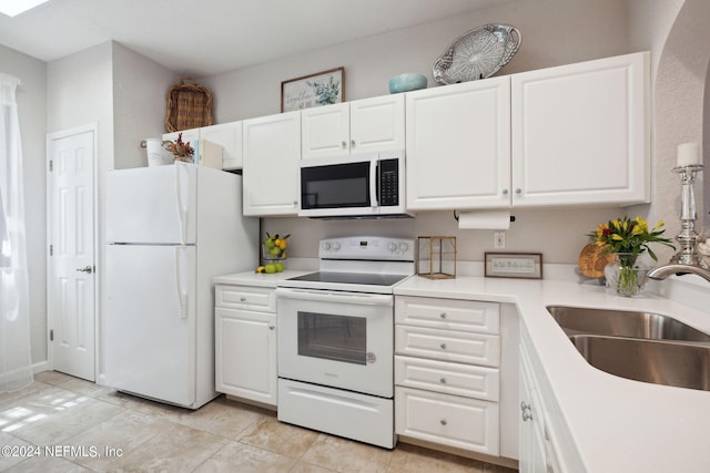 kitchen featuring light countertops, white appliances, a sink, and white cabinetry