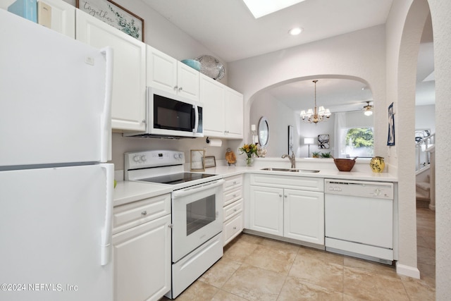 kitchen with white appliances, white cabinetry, light countertops, and a sink