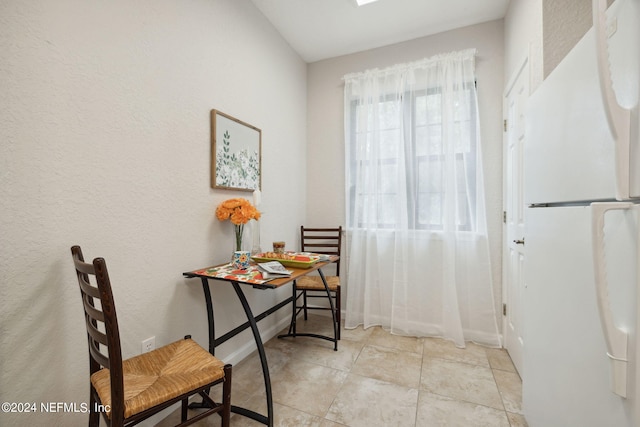 doorway to outside with light tile patterned floors