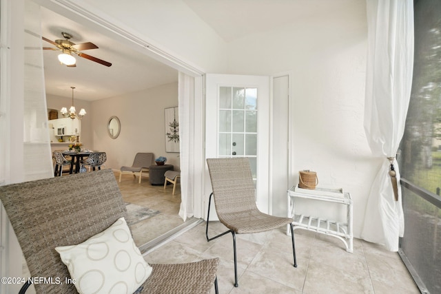 sitting room with ceiling fan with notable chandelier