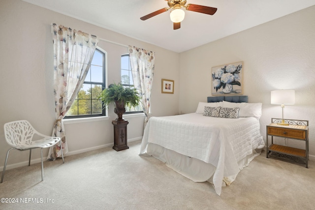 bedroom with ceiling fan, carpet floors, and baseboards