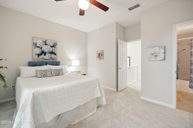 bedroom featuring baseboards, visible vents, ceiling fan, and light colored carpet